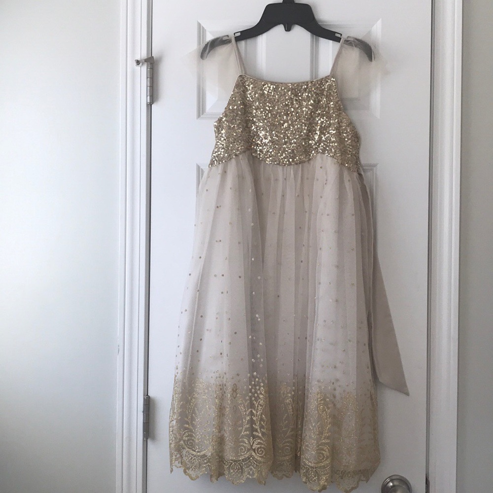 Children’s fancy dress with gold and cream colors.